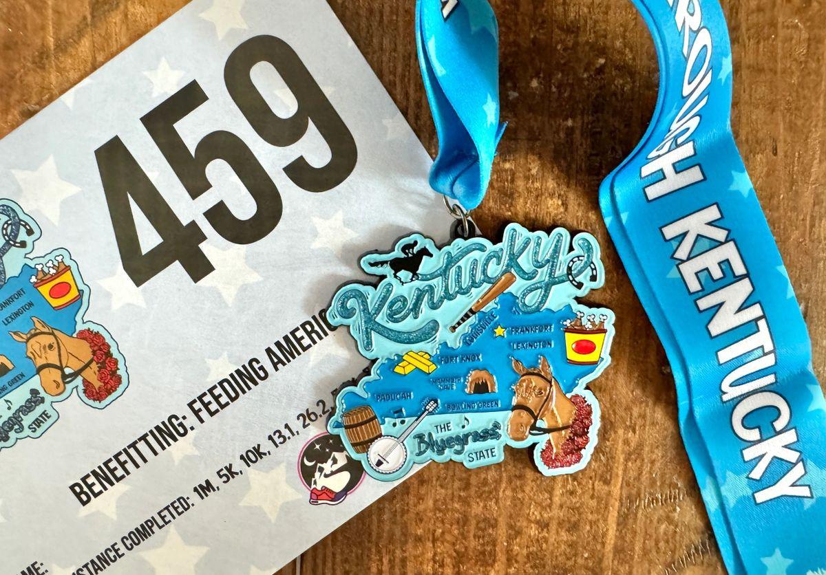 Collection of 50 race medals and bibs from the Race Through America 50 State Challenge by virtualrunevent displayed together.