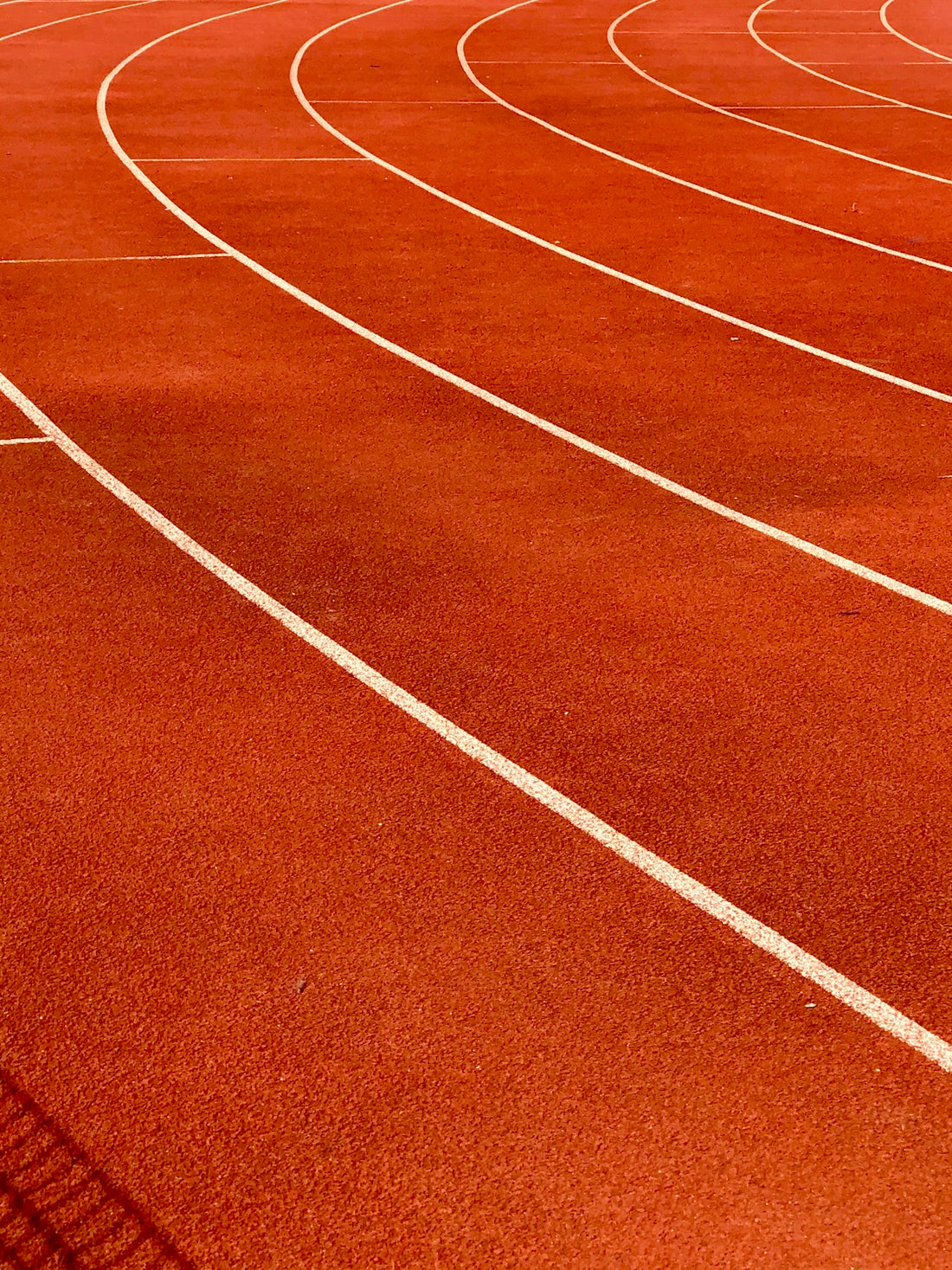 a red running track with white lines on it