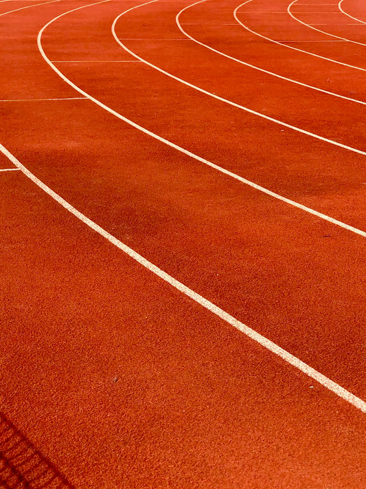 a red running track with white lines on it
