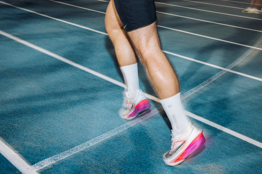 Runner's legs moving swiftly on a track.