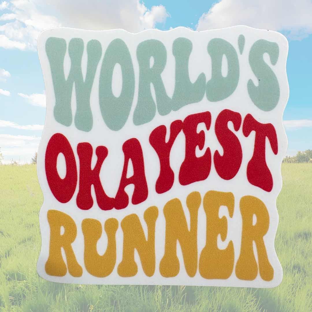 Sticker featuring the "World’s Okayest Runner" design from virtualrunevent, with humorous text on a rectangular sticker background.