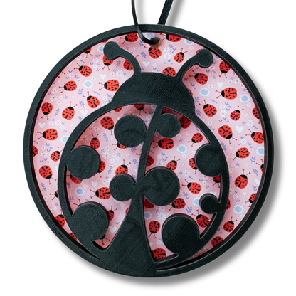 Decorative ladybug medal with layered wood and printed acrylic, featuring a 3.75-inch round design for garden or spring decor.