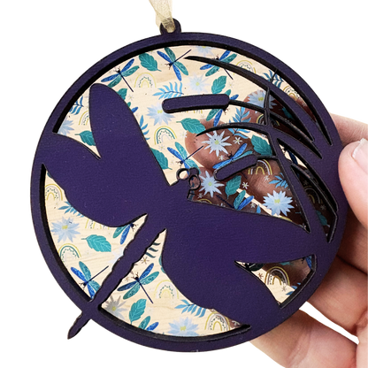 Purple dragonfly ornament made of layered wood and acrylic, measuring 3.75 inches, showcasing intricate detailing.
