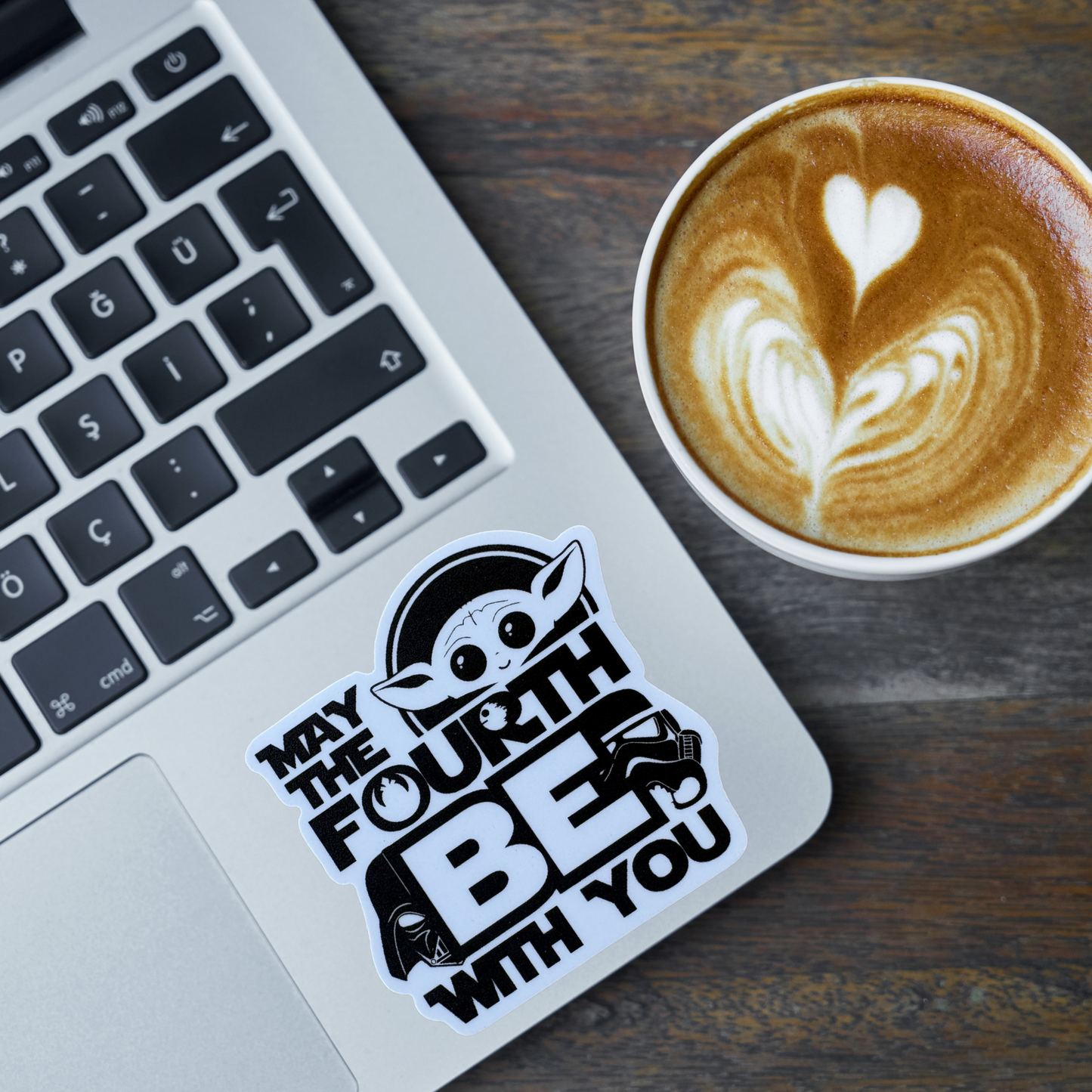 Star Wars May the 4th Be With You sticker featuring bold, colorful text and graphics on a clear background.