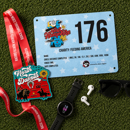Silver race medal for the North Dakota virtual race, featuring engraved details and a ribbon, awarded for completing a 5K, 10K, or marathon.
