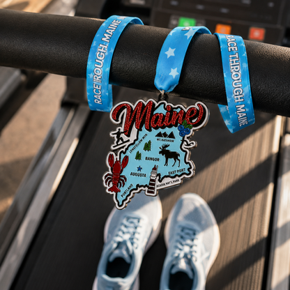 Medal for Race Through Maine Virtual Race 5K, 10K, Half Marathon, or 50 Mile Challenge draped over treadmill.