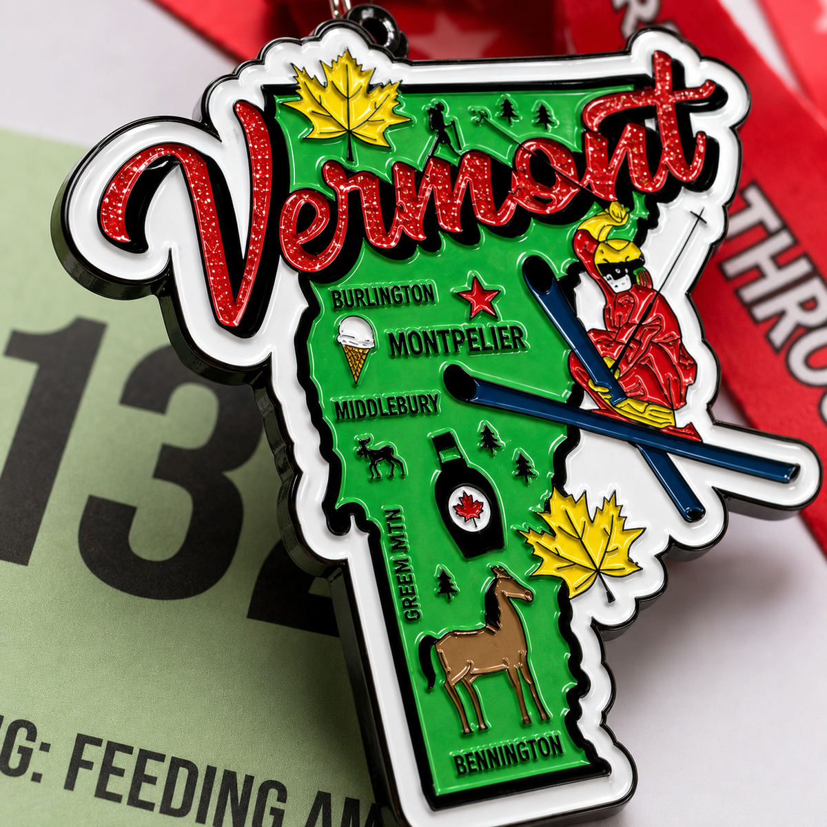 Close-up of a metal medal for the Race Through Vermont Virtual Race by virtualrunevent, featuring engraved race details and Vermont imagery.