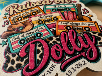 Limited-edition Raised on Dolly Virtual Race 2026 wood medal by virtualrunevent, featuring intricate design and race branding.