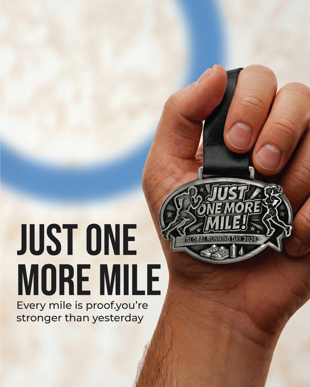 Gold-colored Just One More Mile Race 2026 medal for Global Running Day virtual event, with engraved text and ribbon attachment.